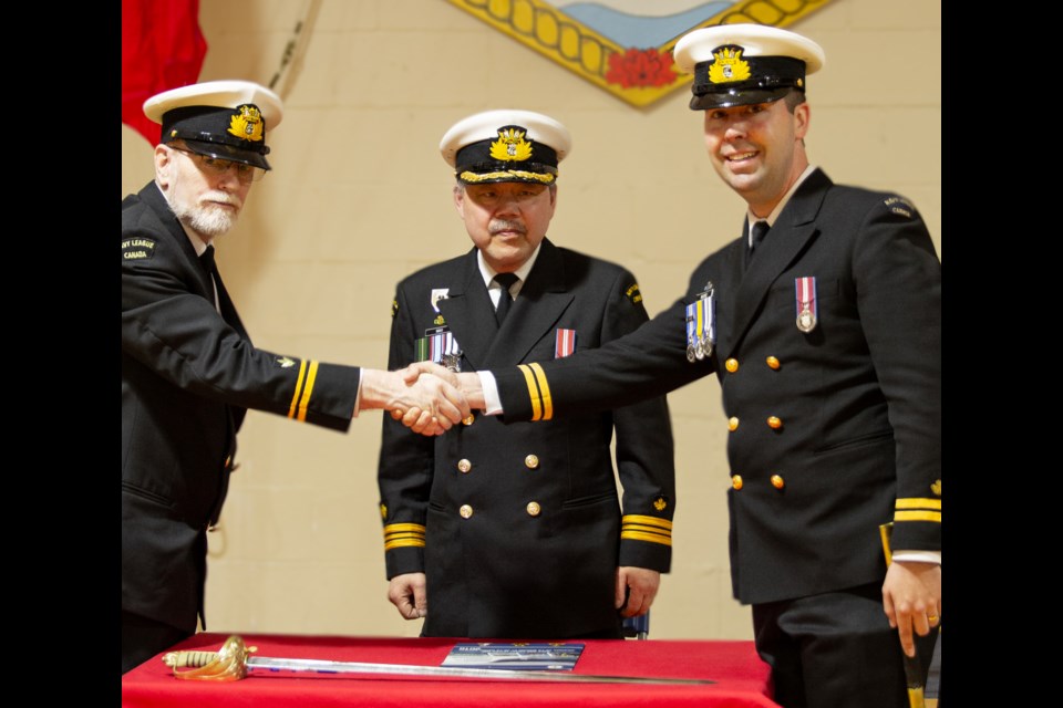 Sub-Lt. (NL) Colin Parkinson takes over as commanding officer from Lt. (NL) Ryan Moore, witnessed by Lt-Cmdr. (NL) Cliff Mah.