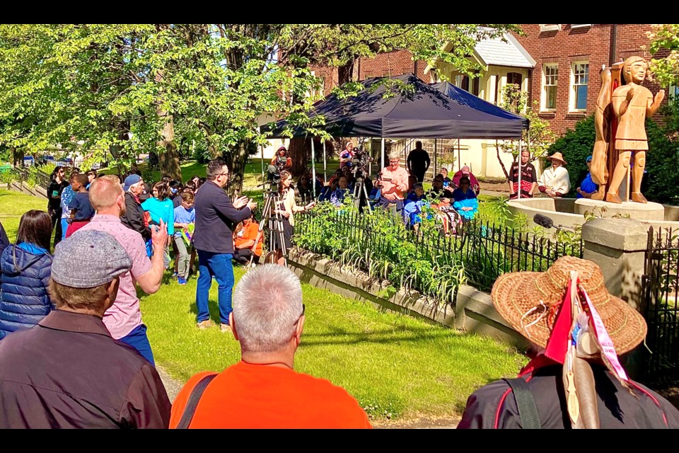 Squamish Nation Councillor Sxwíxwtn (Wilson WIlliams, left of centre) speaking to the crowd at the ceremony held on June 17.