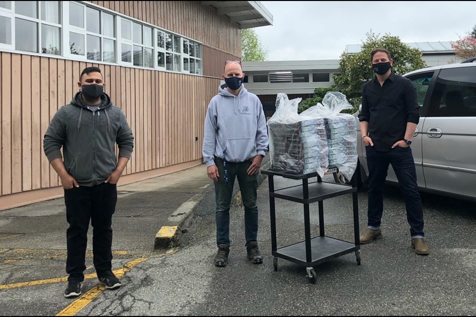 Powerlifter Sumeet Sharma (left) makes a food donation to teachers and staff at West Vancouver's Ridgeview Elementary. 