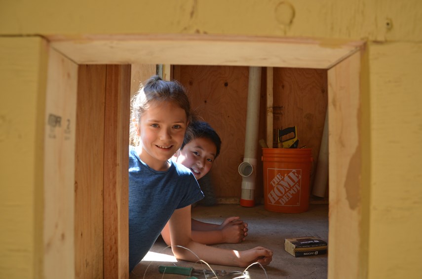 Waldorf School students Briar and Quinten poke their heads inside the chicken coop they and their classmates at the Lynn Valley school have been building this year. 