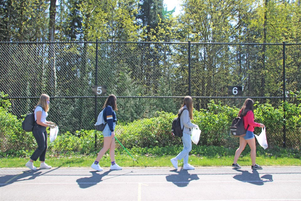 Students at Windsor Secondary walk the perimeter of the track during an Earth Day clean-up initiative on Thursday, April 22, 2021. The school district has launched a community clean-up campaign this week that wraps up on May 31.