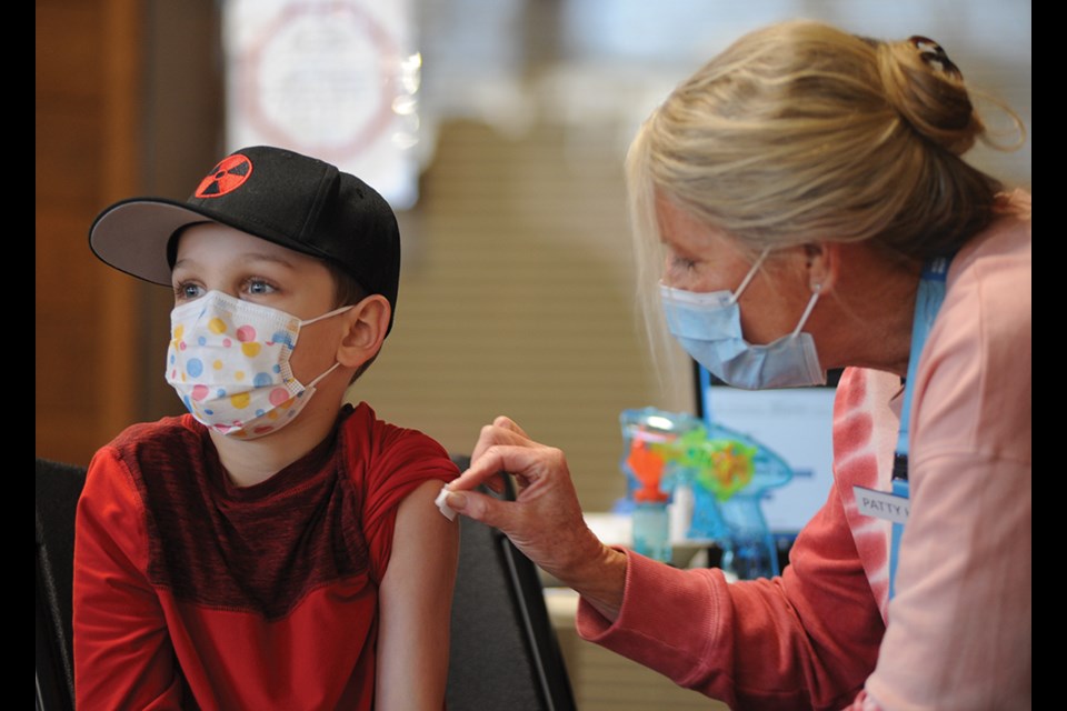 Liam Kenny, nine, gets his shot at North Vancouver's Lloyd Avenue kids' vaccination clinic on Monday (Feb. 14).
 