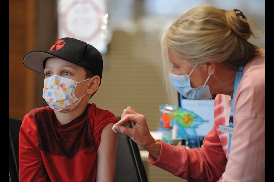 Liam Kenny, nine, gets his shot at North Vancouver's Lloyd Avenue kids' vaccination clinic on Monday (Feb. 14).
 