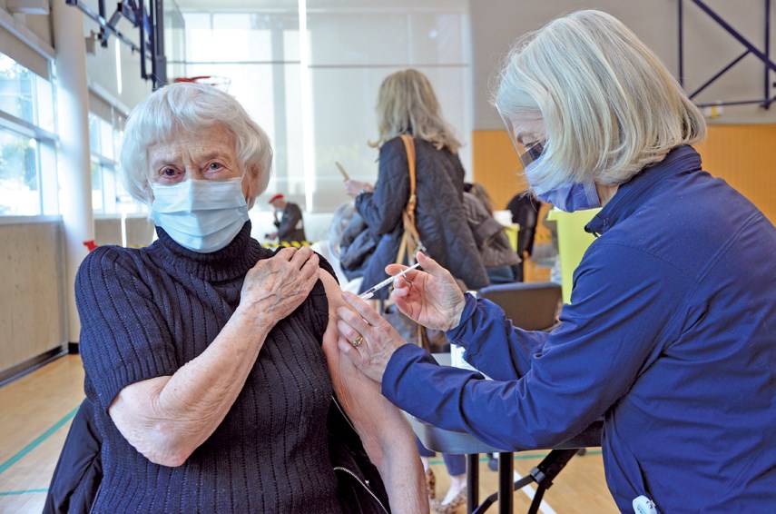 Shelagh Derbyshire receives a dose of the Pfizer vaccine from her daughter Karen Dunn, a public health nurse, in March 2021 at the West Vancouver Community Centre clinic.  