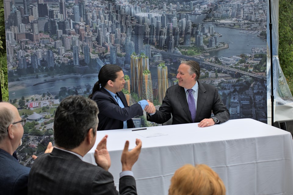 Squamish council chairperson Khelsilem and Vancouver Mayor Kennedy Stewart sign a memorandum of understanding services agreement at a press event Wednesday (May 25).