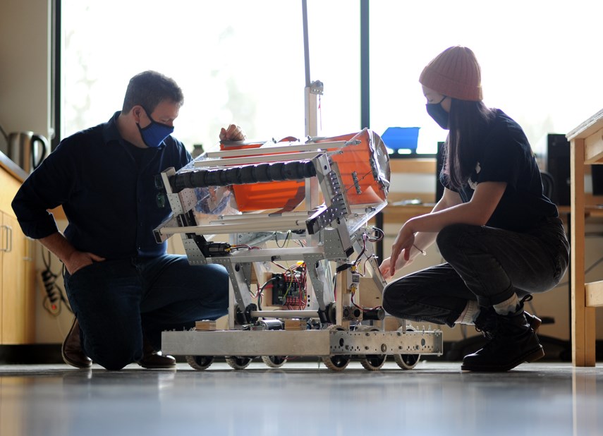 Robotics engineering teacher Rob Olson and student Pippa Crerar discuss robotics projects at Carson Graham Secondary.