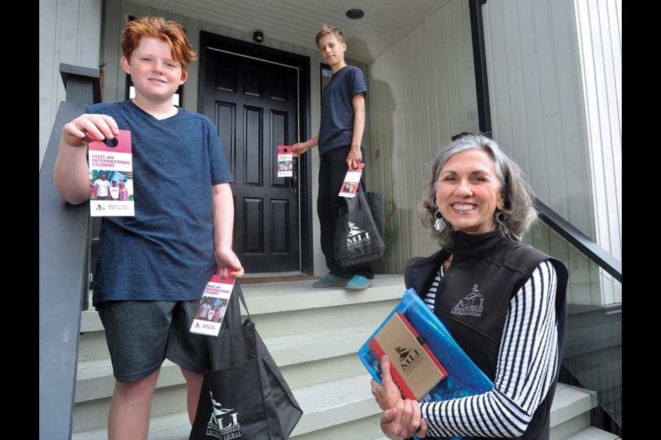 Cheryl Lee, managing director of MLI Homestay, with helpers Gabriel William Henderson (left) and Tom Hoffmann are on a door knocker campaign to raise awareness about the urgent need for student homestay families in North Vancouver.
