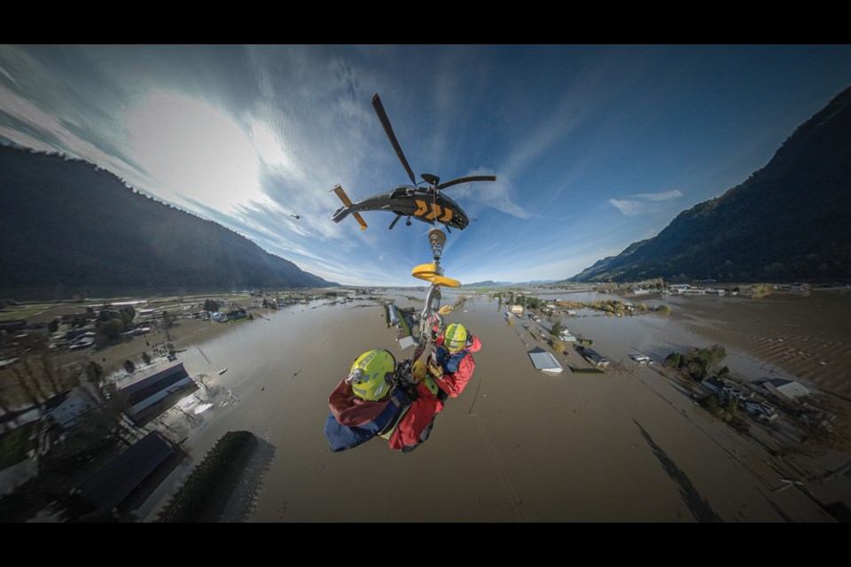 North Shore Rescue members fly over flooded land near Abbotsford on their way to save stranded residents in November, 2021. 