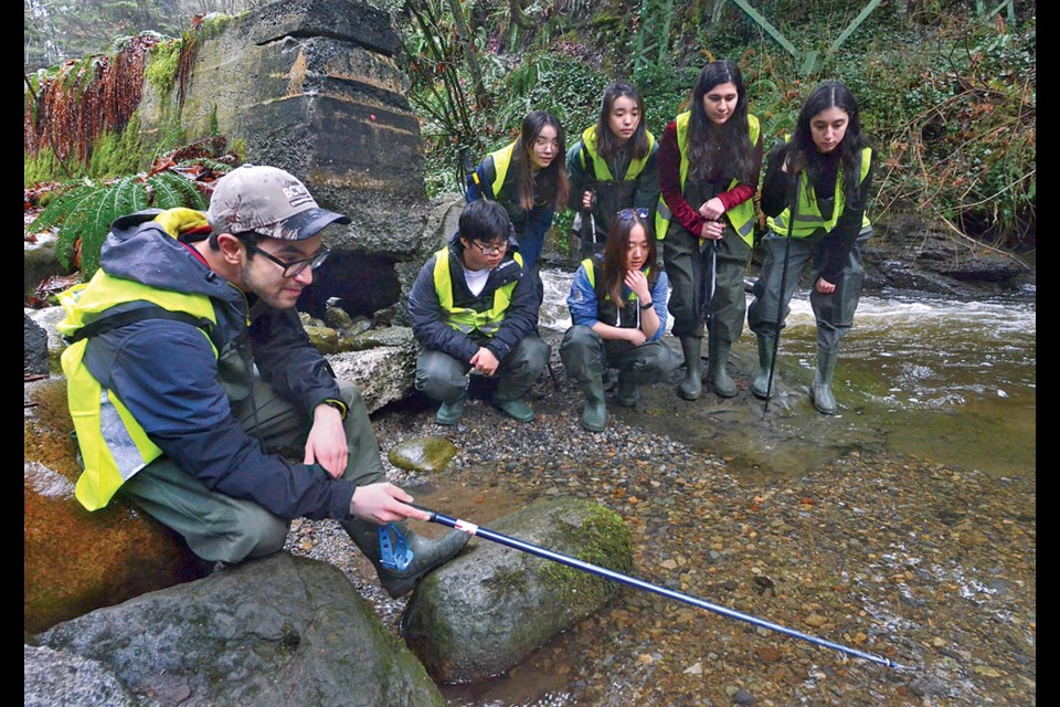West Vancouver Streamkeepers director Joseph McDaniel  discusses salmon habitat with Sentinel and West Vancouver Secondary School students in Brothers Creek, Feb. 6, 2023.