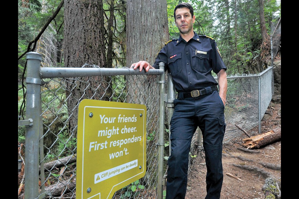 DNV Fire Chief Mike Danks reveals new signs geared to a younger demographic warning of the dangers of cliff jumping in Lynn Canyon Park. | Paul McGrath / North Shore News