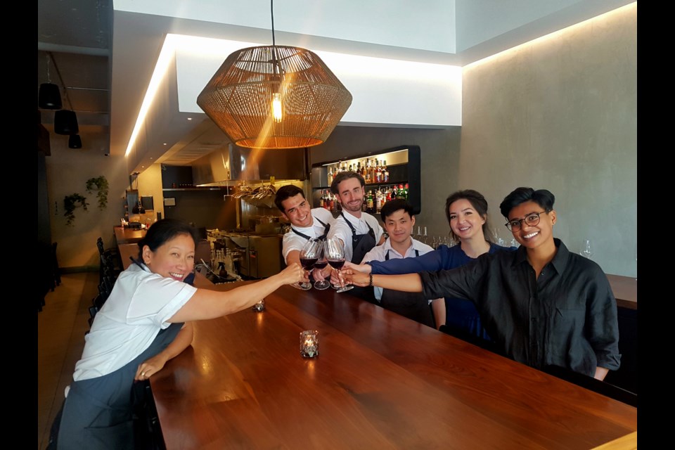 Chef Addy Gowe (left), wine expert Sher DiMarco (far right), owner Brooke Naito-Campbell and the kitchen staff of 16 West.
