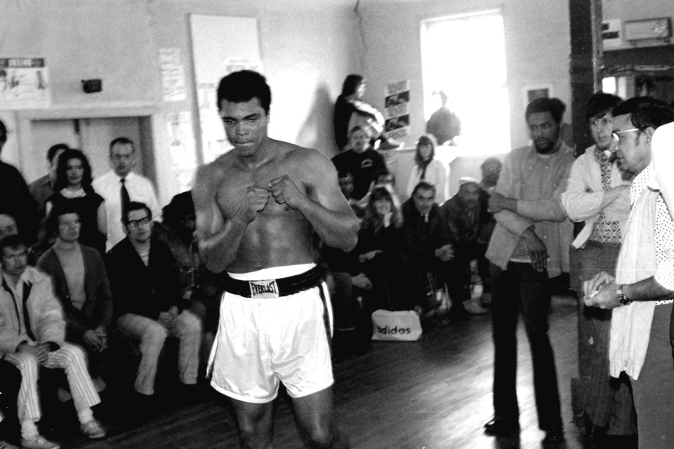 Boxing great Muhammad Ali and trainer Angelo Dundee (far right).