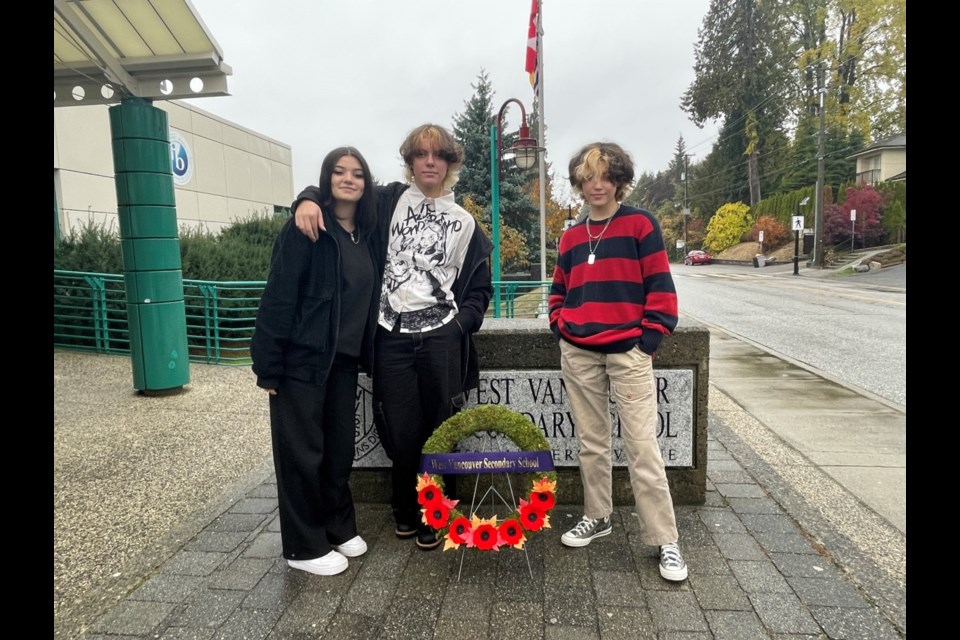 Miya, Ariel and Maria of West Vancouver Secondary School planted white crosses in veterans' graves for Remembrance Day. 
