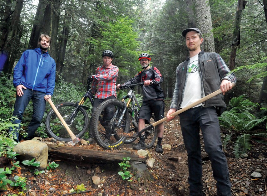 North Shore Mountain Biking Assoc. NSMBA members Kevin Johnstone, David Dean, Alan Bardsley and Joe Woywitka on one of the  soon to be officially sanctioned trails on Hollyburn Mountain above the Cypress Bowl Lookout.