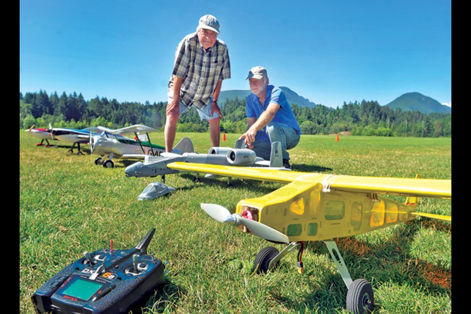 North Vancouver Radio Controlled Flying Club founding member Ron Brasier (left) and Mark Gilbert check out some of the planes ready to take flight.