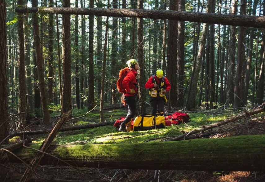 North Shore Rescue members prepare to lift an injured mountain biker off a West Vancouver trail, Oct. 30, 2021.