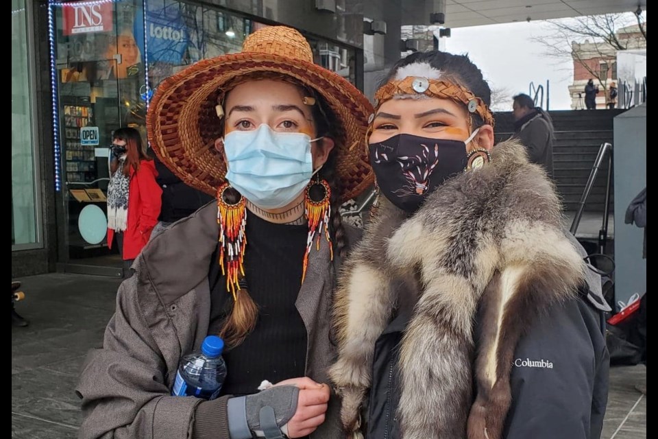 Braided Warriors Scwicweye and Kaylee Wolflinger stand outside the Chubb Insurance building at 250 Howe St. in downtown Vancouver on Monday, March 1. 