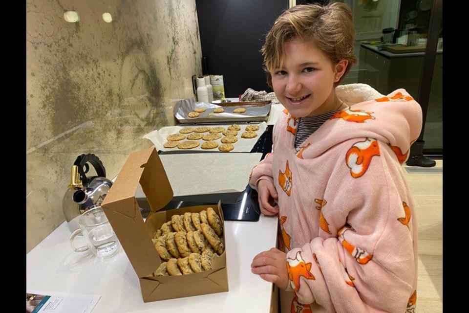 12-year-old Eva Bilbey packages up another batch of cookies for sale with proceeds going to the BCSPCA. Bilbey raised $750 baking cookies and selling them around her neighbourhood.