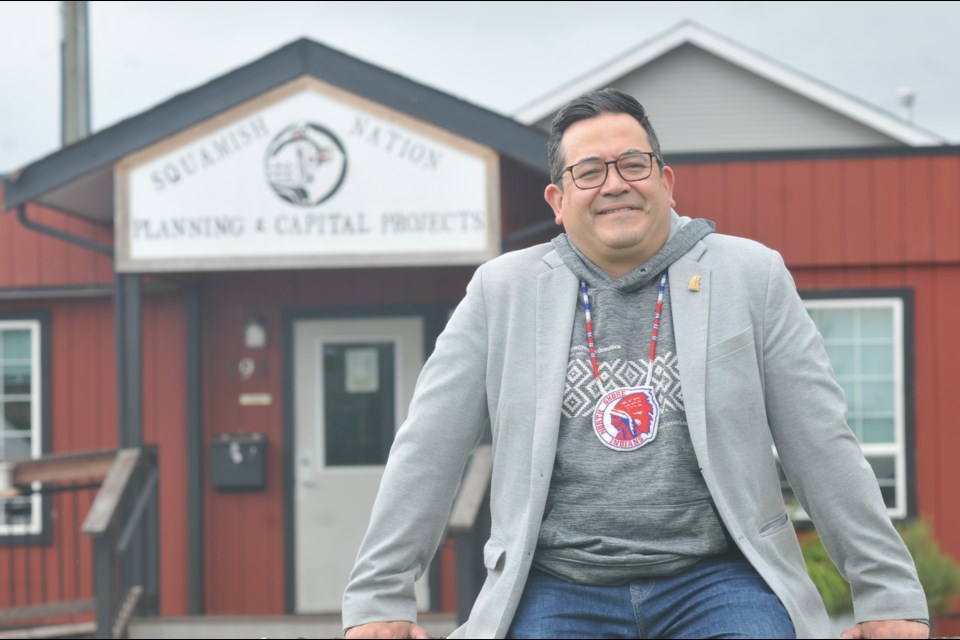 Coun. Sxwíxwtn (Wilson Williams) stands outside Squamish Nation's planning and capital projects building, on Monday, July 18, 2022. Williams will be promoting the census at Amalgamation Day on July 23.