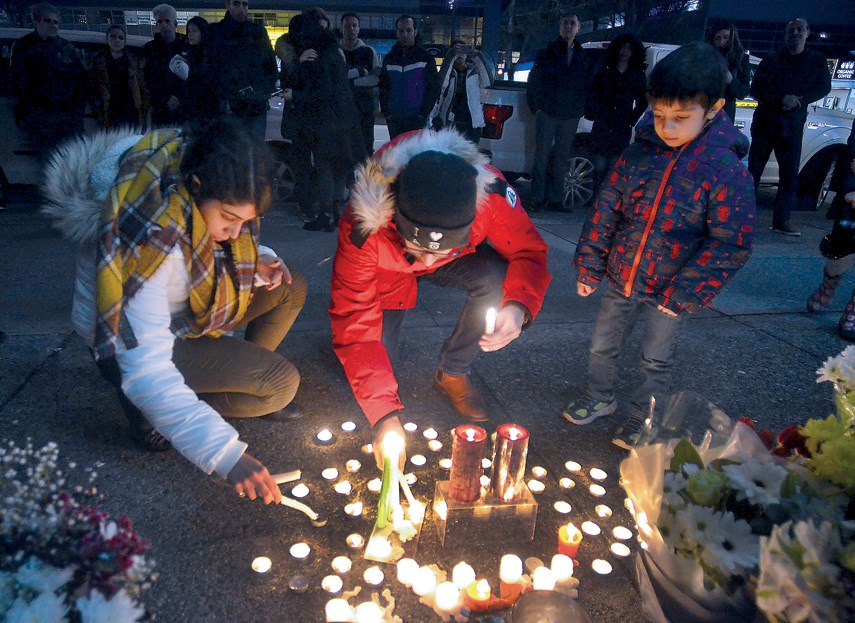 Hedy Vaseli and her brother Hooman Vaseli join members of North Shore’s Iranian community in paying their respects to victims of downed Ukrainian Flight 752, outside Amir Bakery in January. The bakery owner’s wife and daughter were among 176 passengers and crew who perished when the commercial flight was shot down by the Iranian army shortly after takeoff from Tehran’s airport.