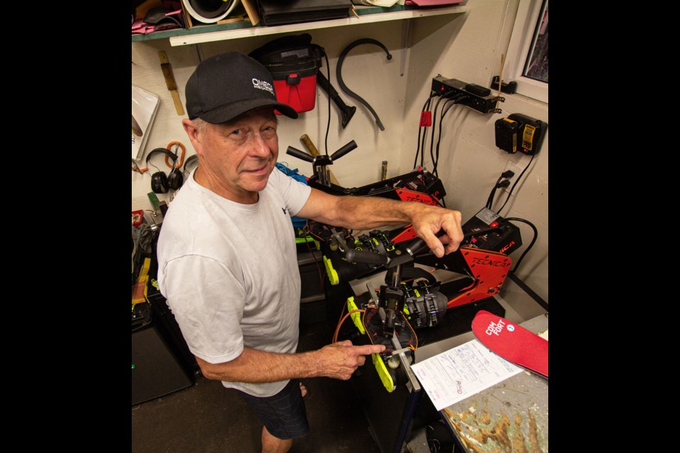 Paul Zirk, founder and owner of The Destination Slope & Surf Outfitters, working on a custom boot-fitting.