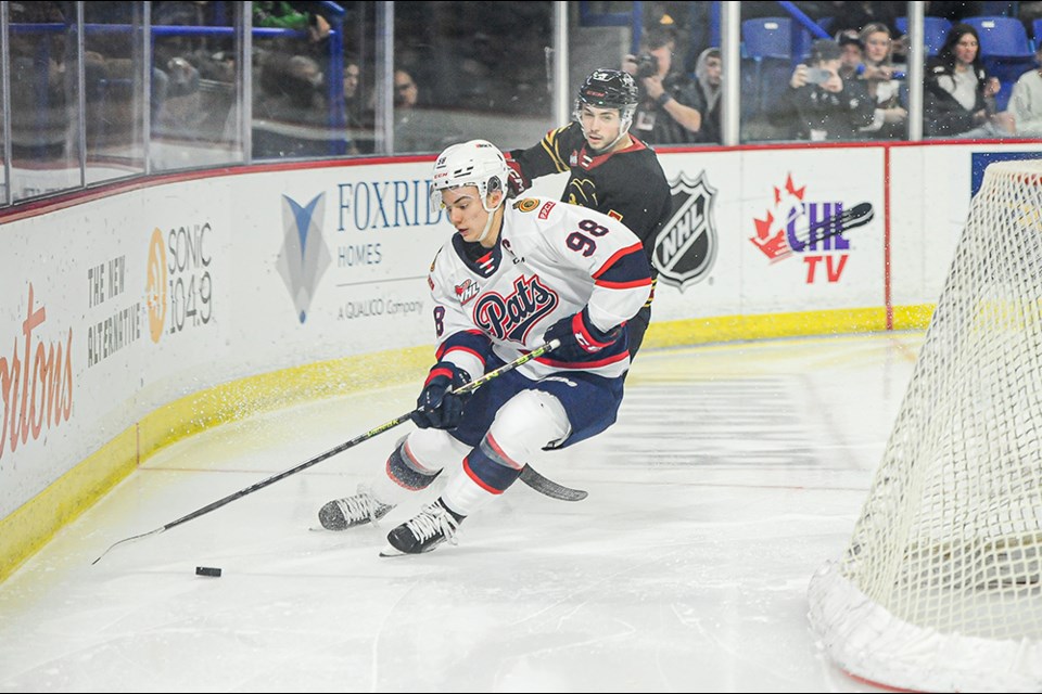 Connor Bedard makes a play for the Regina Pats in a Nov. 25 game against the Vancouver Giants at Langley Events Centre. 