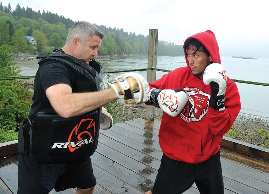 Former Canadian Olympic boxer Manny Sobral coaches boxer Jacob George at a waterfront boxing ring on Tsleil-Waututh Nation lands. George recently scored a first-round TKO in his professional boxing debut. 