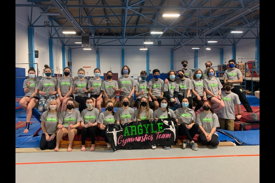 École Secondary's large gymnastics squad is one of several North Shore high school teams sharing mental health messages through the Buddy Check for Jesse program.