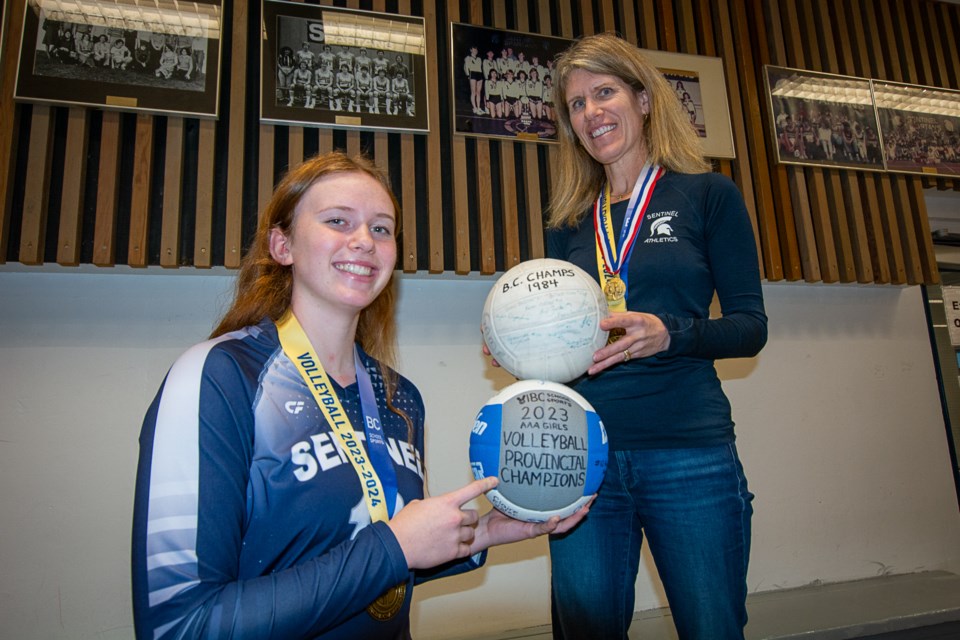 Karissa Kirkwood and her mom, Spartans co-coach Karen Kirkwood, compare their championship-winning volleyballs from 2023 and 1984.