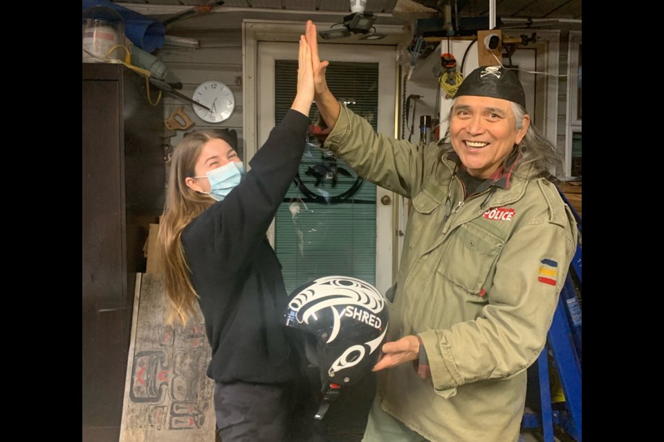 West Vancouver skier Mollie Jepsen meets with Squamish Nation artist Xwalacktun (Rick Harry), who designed the graphics for her new helmet. Jepsen will wear the helmet in competition for the first time at the Paralympic Games beginning March 4 in Beijing. 