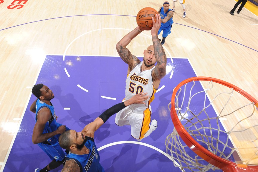 Robert Sacré of the Los Angeles Lakers drives to the rim against the Dallas Mavericks during an NBA game in 2015. The North Vancouver native is back on the B.C. basketball scene as the assistant GM for the Fraser Valley Bandits. 