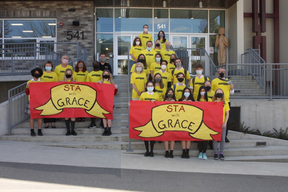 Members of the STA With Grace running team get ready for the Vancouver Sun Run. The team is running in honour of Grace Haines, a classmate who was seriously injured in a hit and run collision in January of 2021. (Note this photo is a composite image due to the school's COVID restrictions).