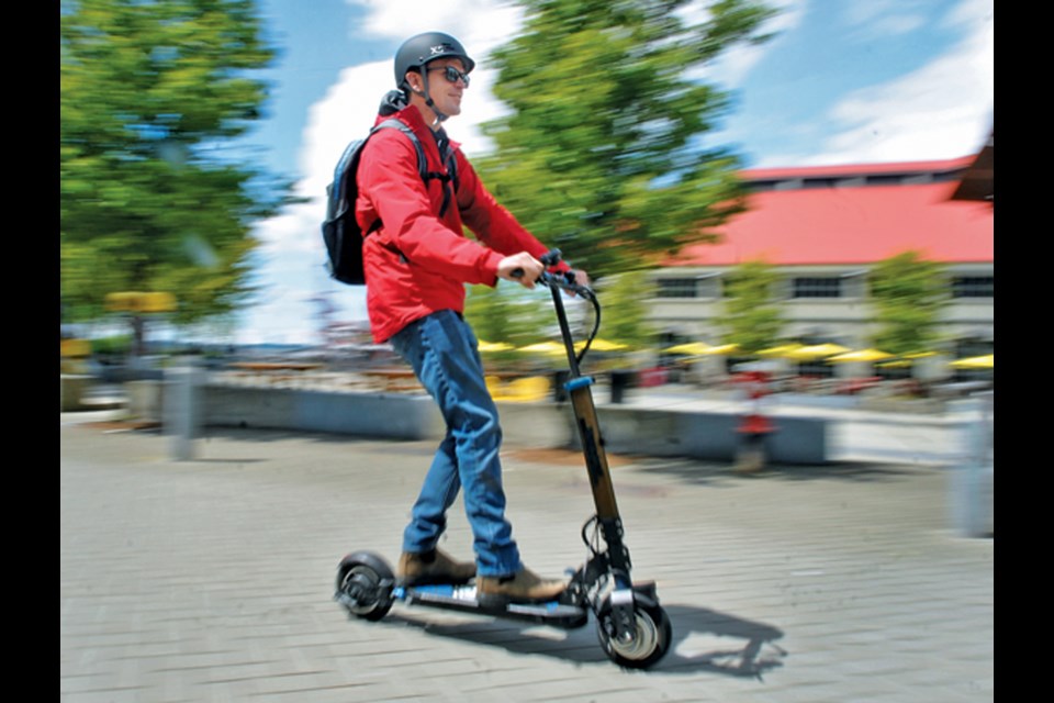 North Shore News reporter Brent Richter tests out an e-scooter on the Spirit Trail in North Vancouver, May 9, 2022.