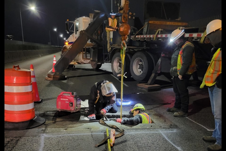 Contractors work on a large hole opened up in the Ironworkers Memorial Second Narrows Crossing,  Jan 3, 2022.