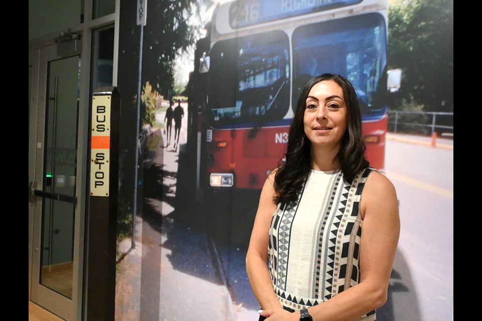 Zoe Mackoff de Miranda, director of MONOVA, waits for her "bus" inside the Museum of North Vancouver's new exhibit on North Shore transportation. | Abby Luciano / North Shore News