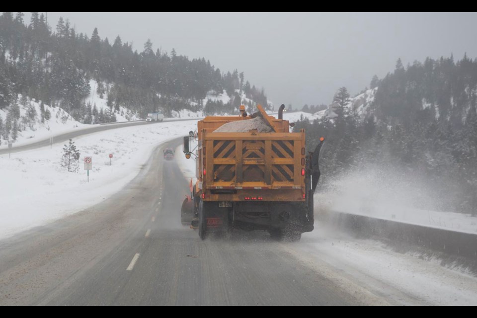A snow plow scrapes a B.C. highway clean. When driving in winter conditions, it is important to plan ahead. 