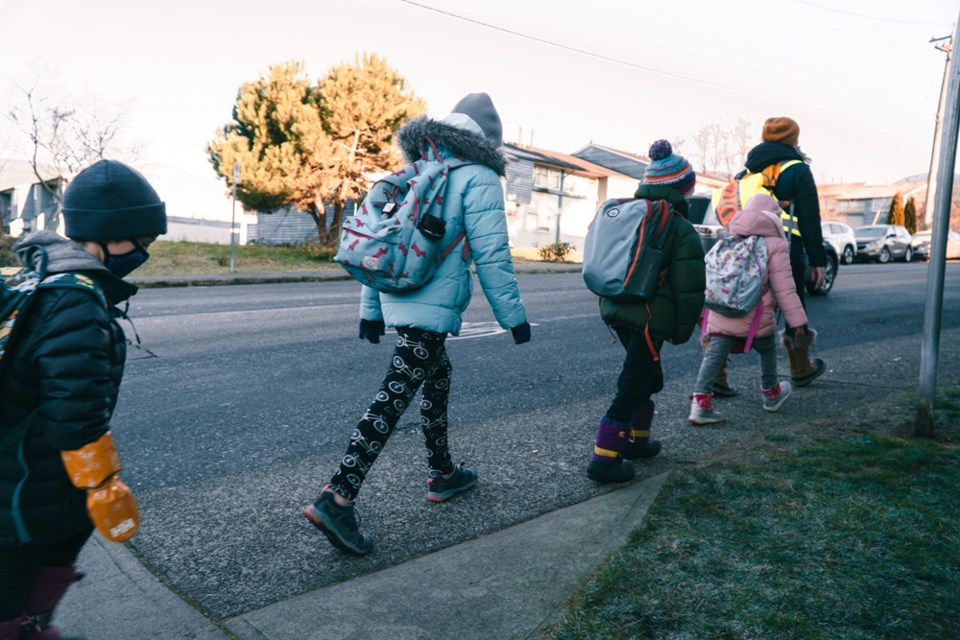 Kids make their way to way to class with a "walking school bus," one of three main action plan items promoted by Student Transportation Services to discourage parents from driving their kids to school. 