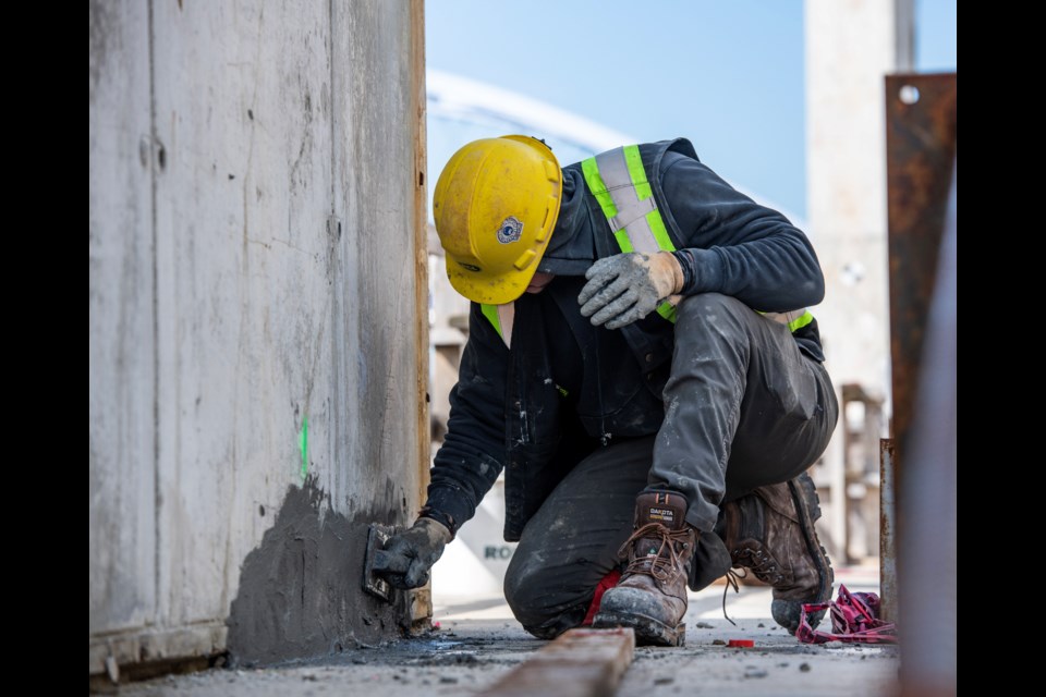 A worker fixes one of a large number of deficiencies Metro Vancouver says needed repair in the sewage plant under construction in North Vancouver.