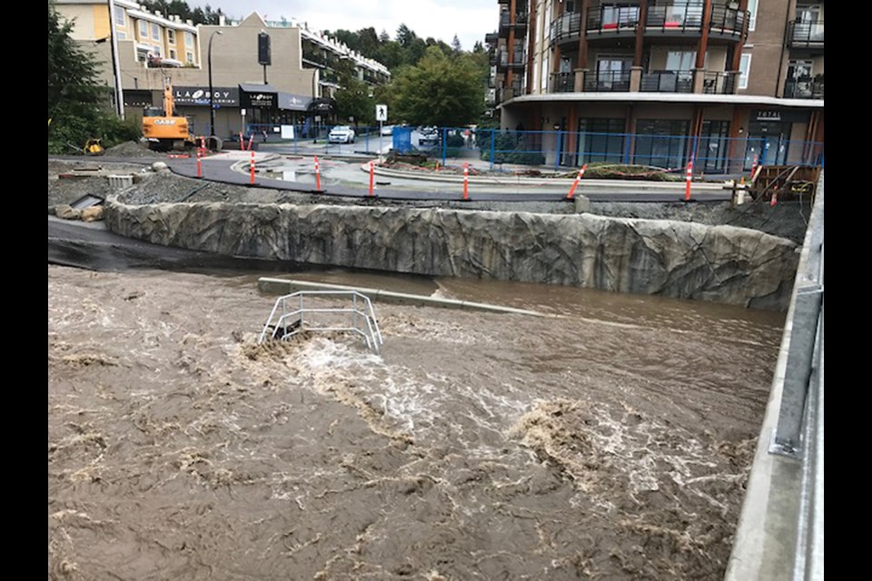 North Vancouver's Mosquito Creek swells as an atmospheric river dumped rain on the North Shore,  Oct. 15, 2021. Residents are concerned about the safety of the pathway under the bridge.