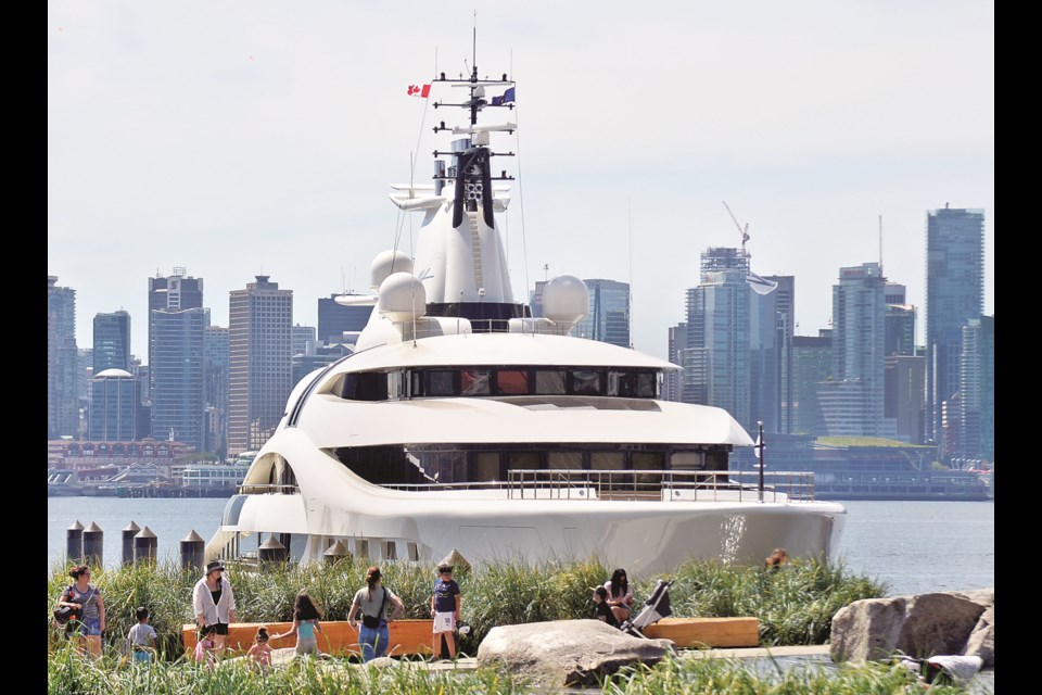Superyachts and summer strollers sparkle in the summer sunshine at the Shipyards in North Vancouver.