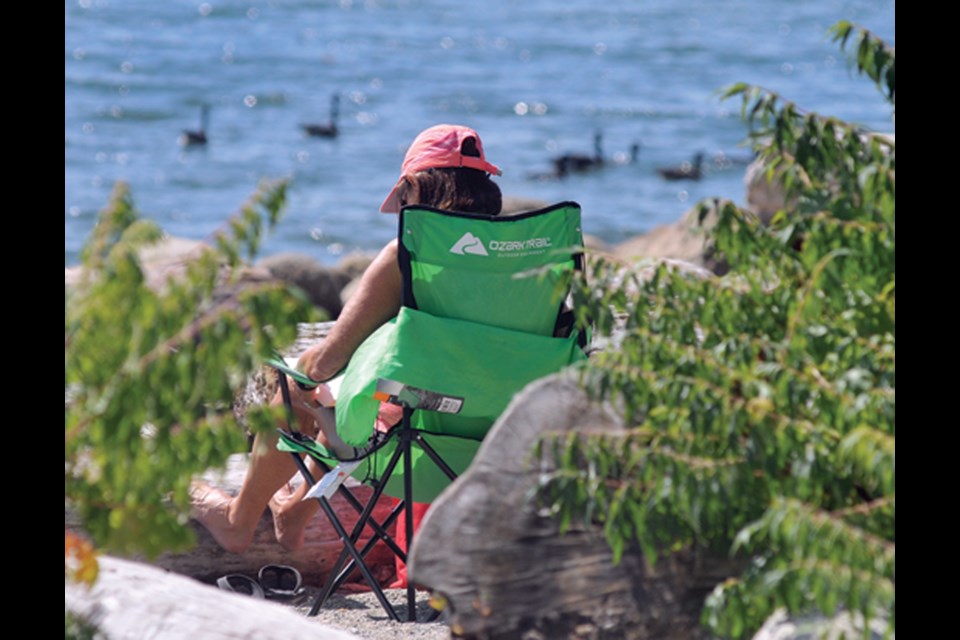 Continued warm weather means North Shore residents will still be able to bask in some fall sunshine this weekend. Here, folks enjoy the sun at Ambleside in August 2022.