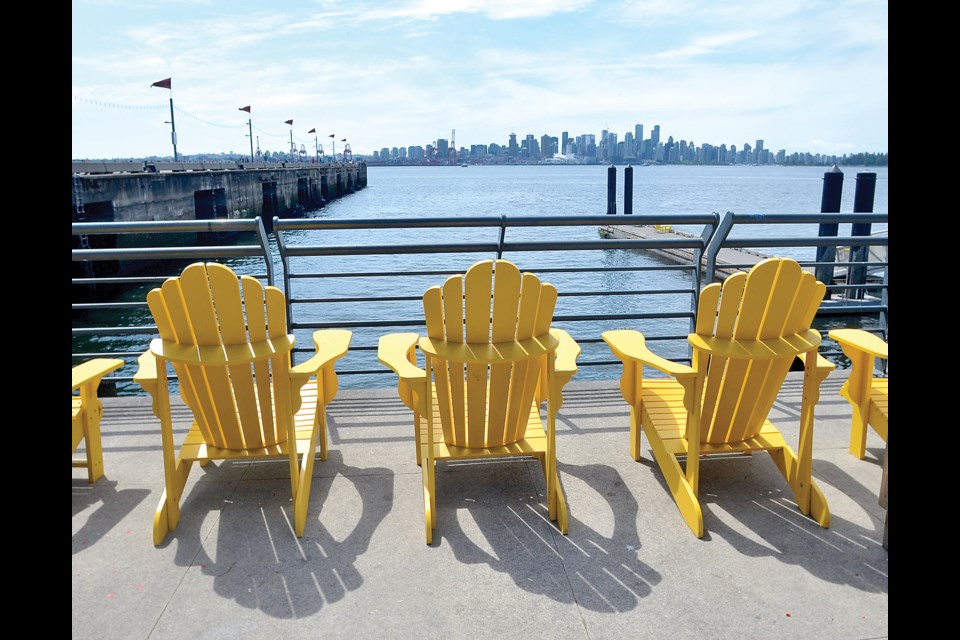 Comfy chairs enjoy a sunny summer day on at the Shipyards in North Vancouver.