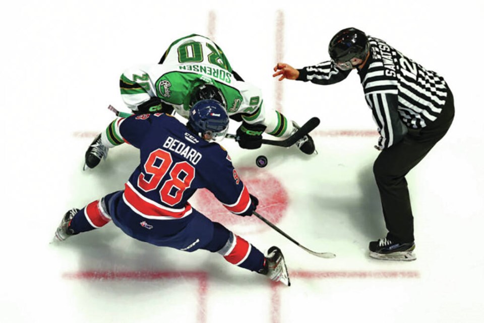 Connor Bedard takes a faceoff for the Regina Pats in a game against the Prince Albert Raiders on Oct. 12, 2022. | Keith Hershmiller Photography / Regina Pats 