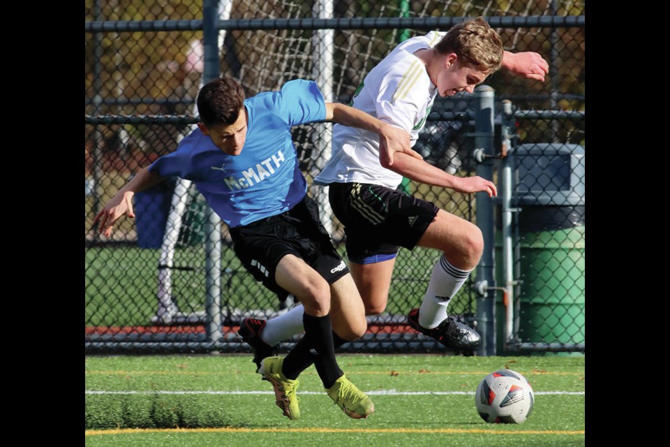 Riley Dunn of the Argyle Pipers scoots by a McMath defender in the senior boys AAA provincial soccer championships played last week in Burnaby. The Pipers made it to the final, picking up silver after losing to Reynolds Secondary in a shootout. | Mario Bartel / Tri-City News 