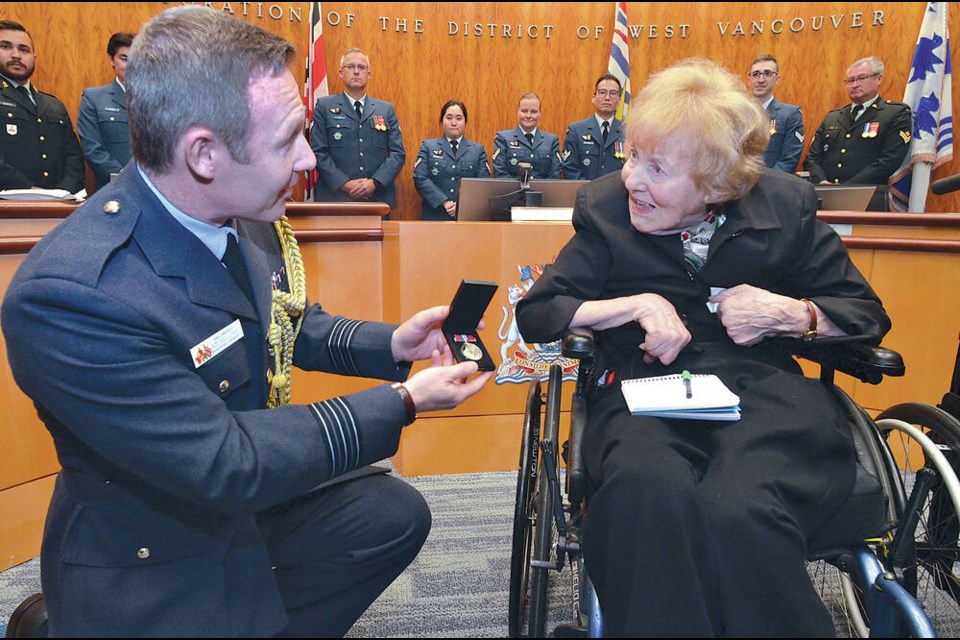 Royal Air Force Wing Commander Adrian Mellors presents 98-year-old West Vancouverite Joyce McKay with her British Commonwealth War Medal 1939-1945 at a special ceremony at West Vancouver municipal hall, Nov. 14, 2022. McKay served in the Women's Auxiliary Air Force in the Second World War. | Paul McGrath / North Shore News 