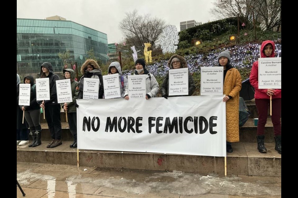 A small crowd gathers in Vancouver on Dec. 27 to pay respects to 10 B.C. women killed during domestic violence incidents. | Hilla Kerner