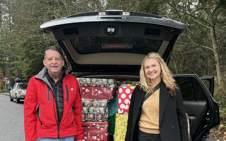 Paul Butler, of North Shore Youths Safe House, and teacher Marta Orellana with the collected gifts for the youth shelter. | Marta Orellana 