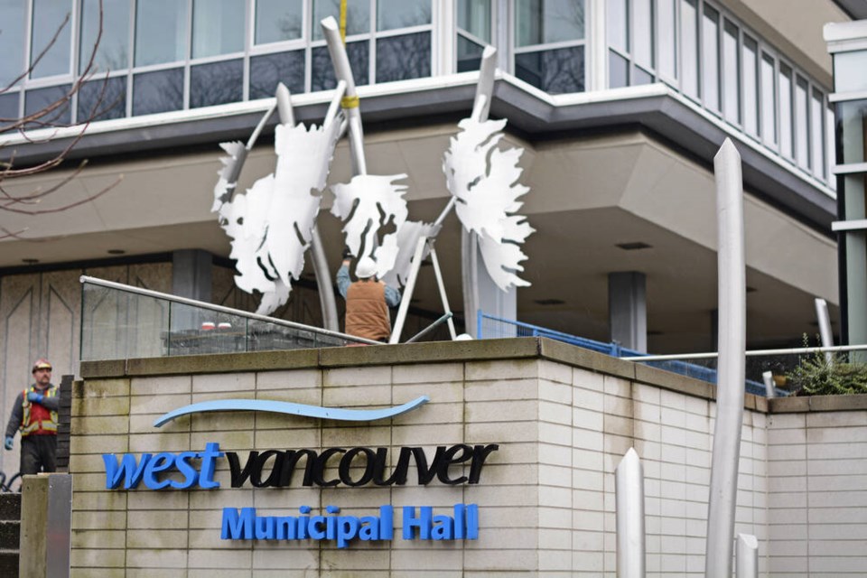 Workers install a new public art piece at West Vancouver municipal hall on Friday. | Nick Laba / North Shore News 