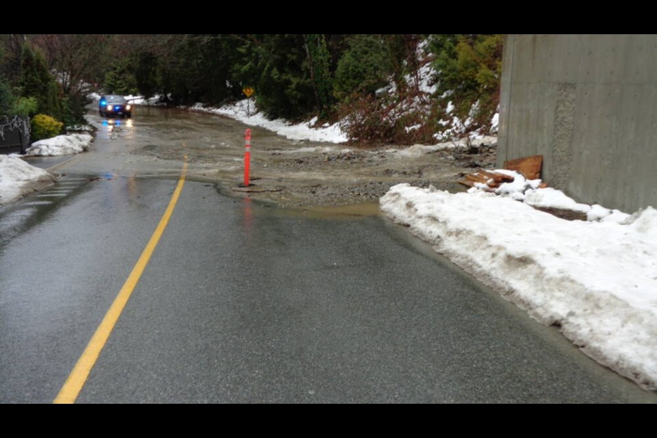 Heavy rain and snowmelt on Dec. 24, 2022, causes stormwater to enter the unfinished 5 Creeks Flood Protection Project and spill onto the roadway. | David Reinsch 