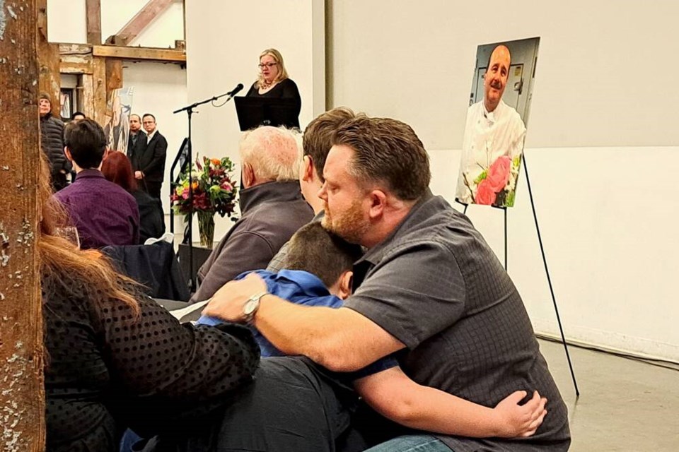 Members of Ralf Dauns's family embrace at a celebration of life last Friday. It was announced at the event that Dauns's nephew Evan Paul would be carrying on the legacy of The Soup Meister. | Nick Laba / North Shore News 